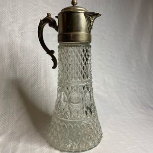 Antique pitcher cut crystal with silver plate top.